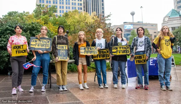 People outside with signs