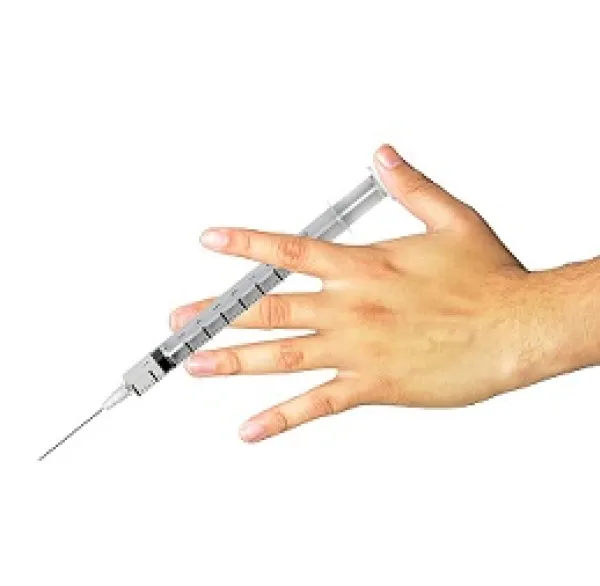 Hand holding a syringe