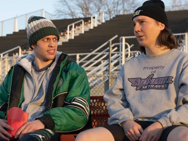 Two guys sitting outside