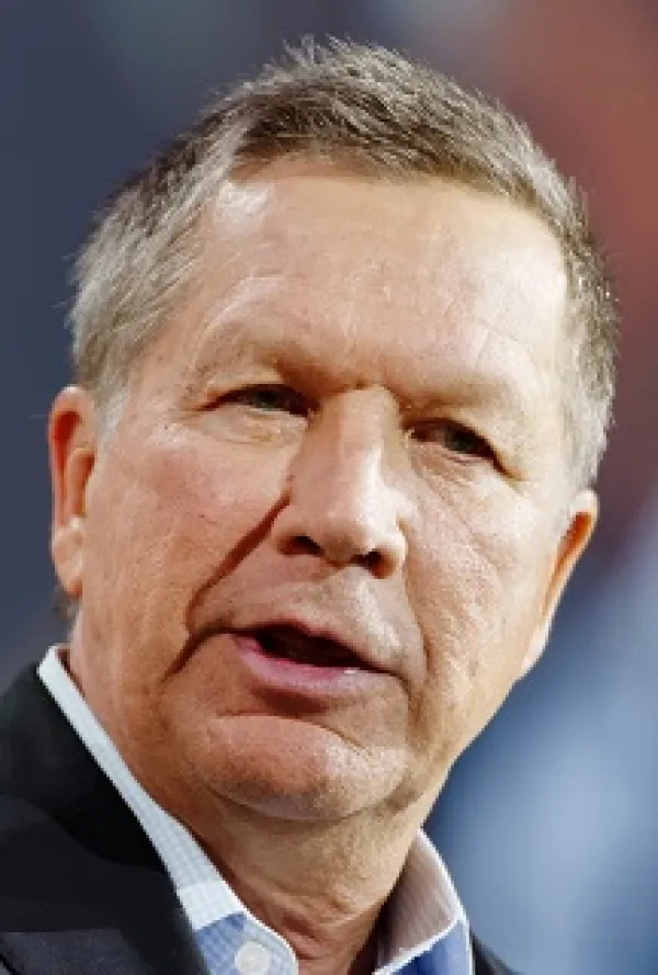 Extreme close up of white man with gray hair talking out the side of his mouth