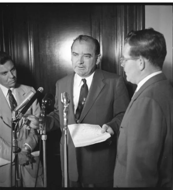 McCarthy talking at a microphone