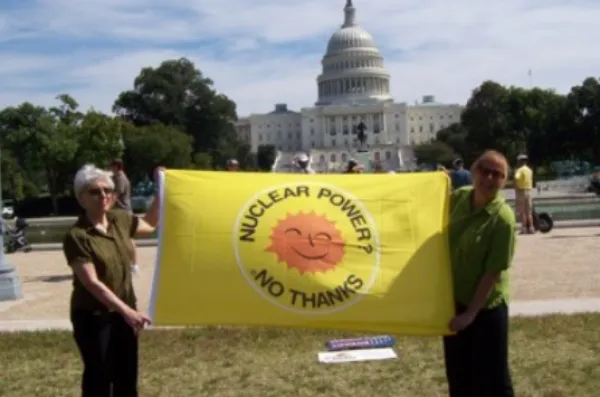 People holding sign saying Nuclear Power No Thanks in front of Congress