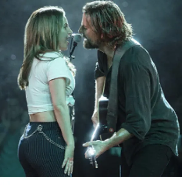Side view of man and woman singing to each other into a mic, man is playing guitar