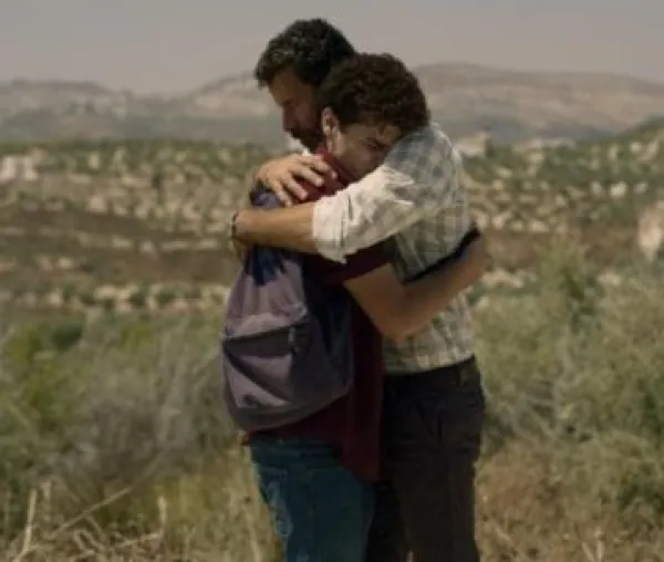 Two men hugging