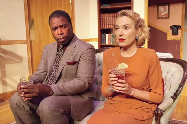 Black man and white woman sitting on a couch